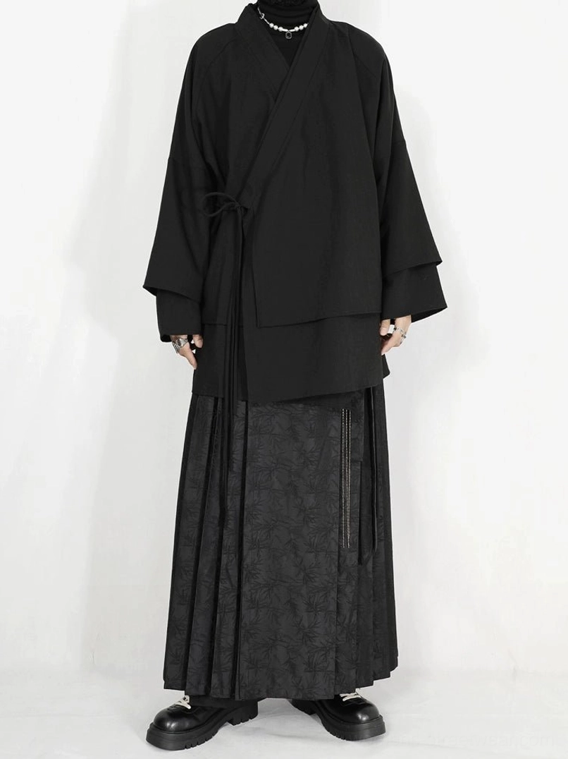 Black jacquard pleated maxi skirt styled with layered wrap top in contemporary Hanfu-inspired streetwear look