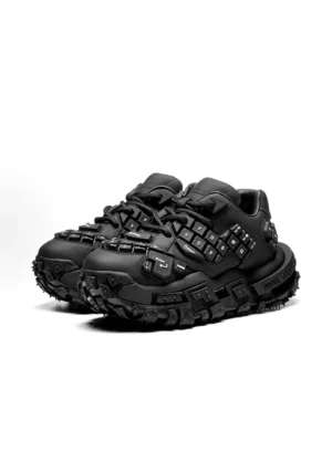 Front three-quarter view of black keyboard chunky dad sneakers with keycap-inspired upper details, lace-up construction, matte finish, and rugged platform tire-tread outsole