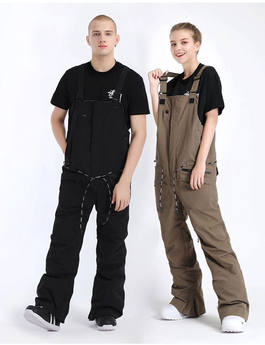 Black and khaki waterproof utility bib snow pants in a studio half-profile view, highlighting adjustable waist drawstrings and relaxed snowboarding fit