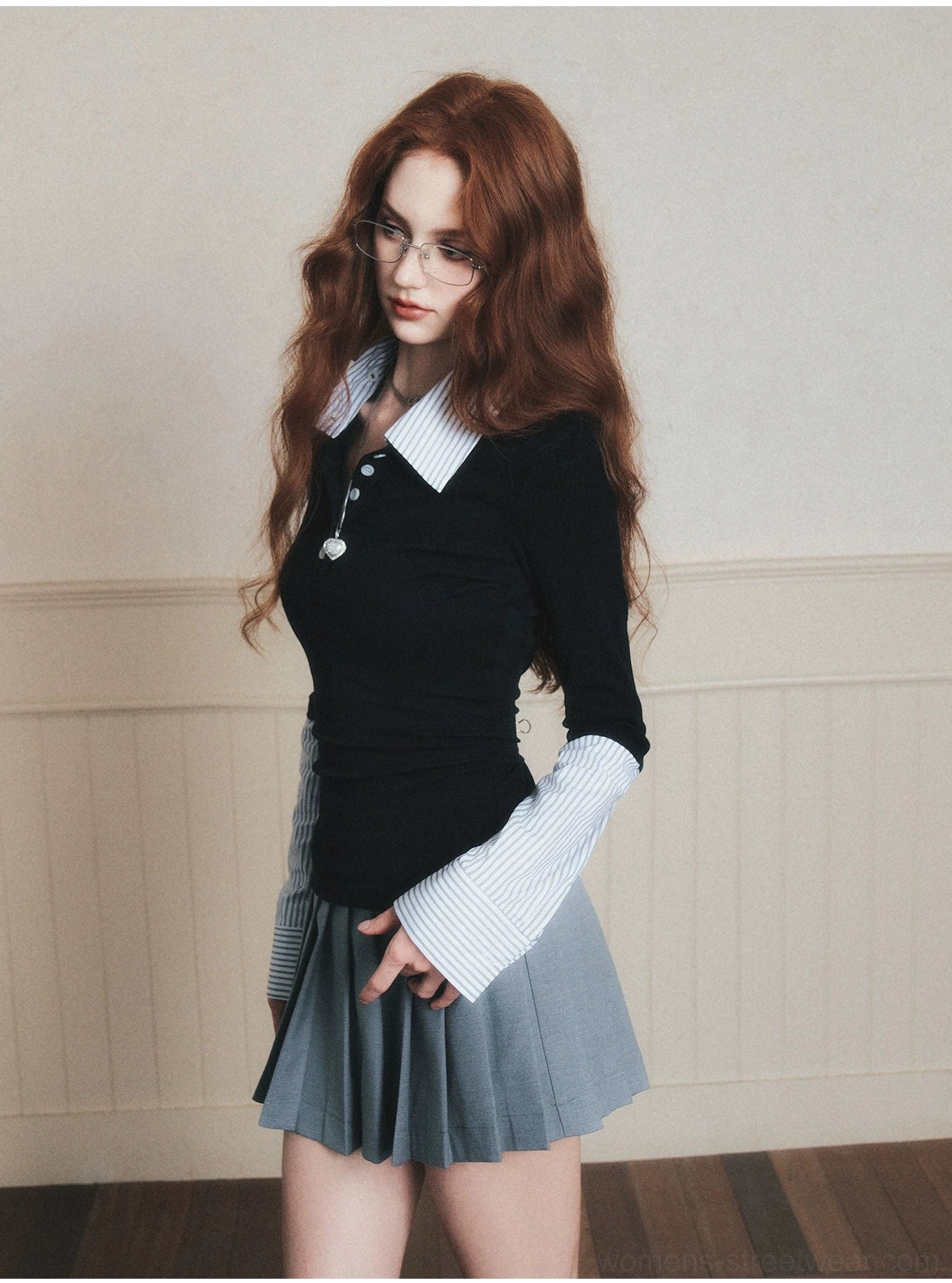 Black knit polo top with pointed striped shirt collar extended layered cuffs and front buttons close side view