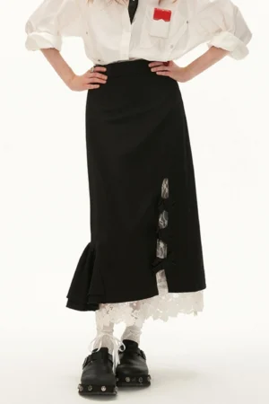 Back view of black lace bow side-slit midi skirt showing the ruffled hem, contrasting lace underlayer, and streetwear outfit styling