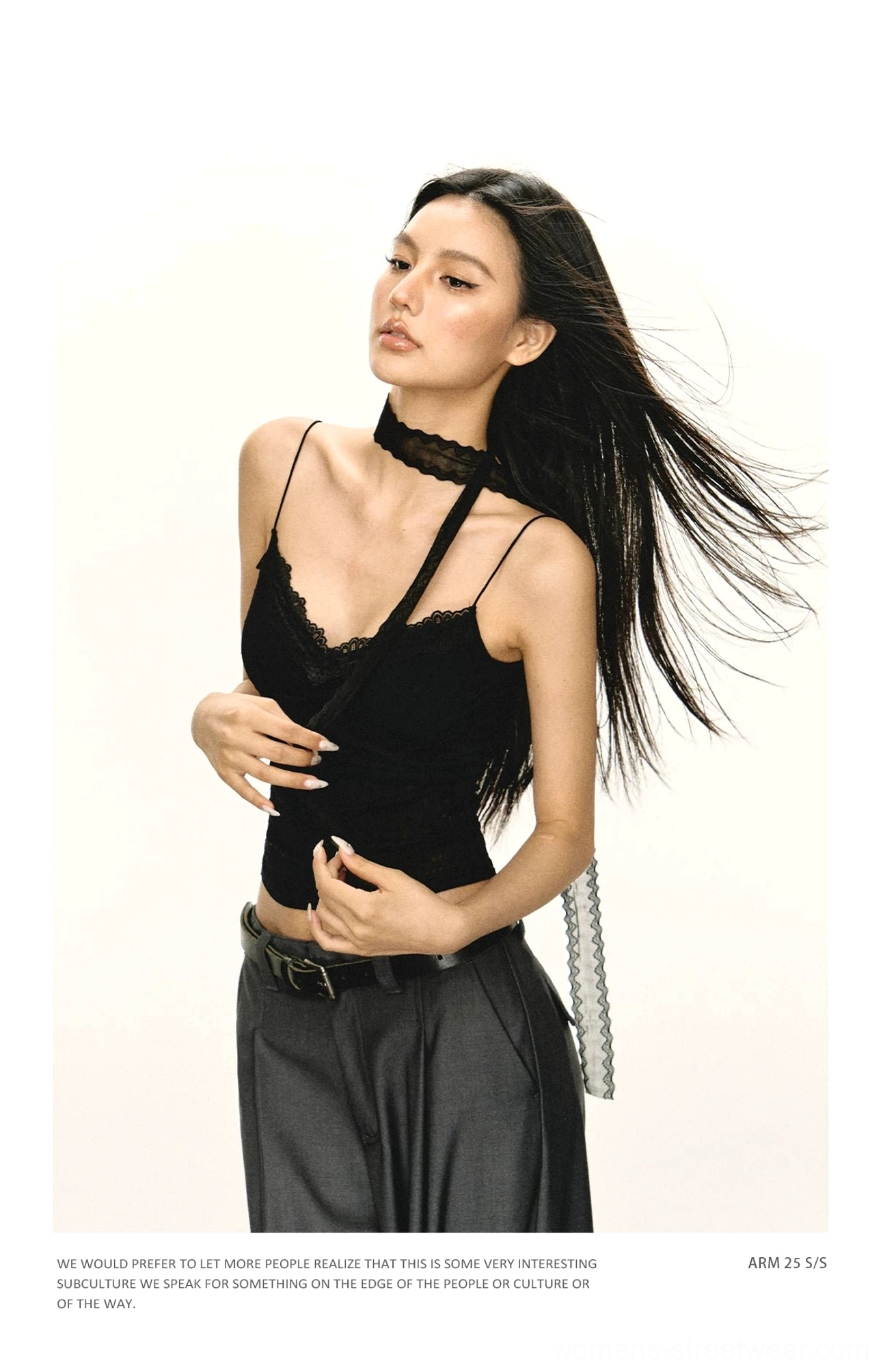 Side view of black lace trim camisole top with asymmetrical spaghetti straps and attached lace choker detail