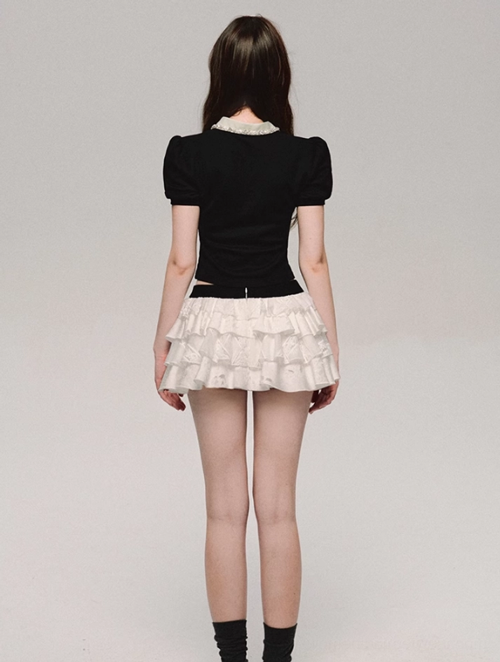 Back view of black cropped lace collar polo top with puff sleeves and visible contrast lace collar trim