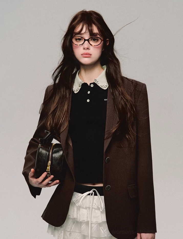 Black cropped polo top with lace collar worn under a relaxed brown single-breasted blazer