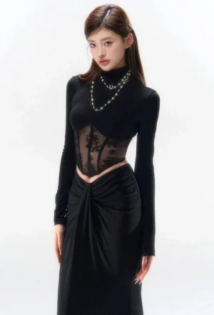 Black lace corset turtleneck evening two-piece set with fitted long sleeves, sheer floral waist panel, twisted floor-length maxi skirt, and layered pearl styling