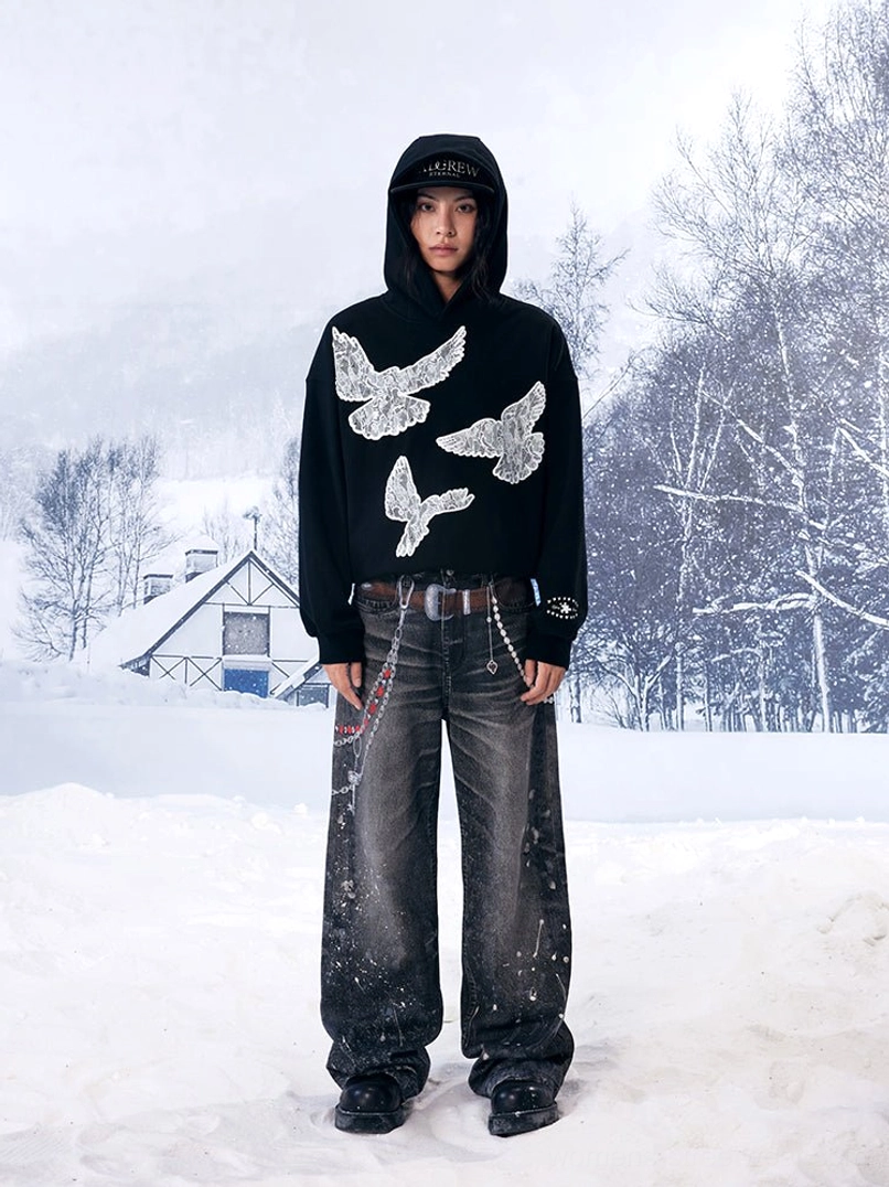 Full-body black lace dove hoodie outfit styled with straight-leg vintage jeans, leather belt and minimalist urban accessories