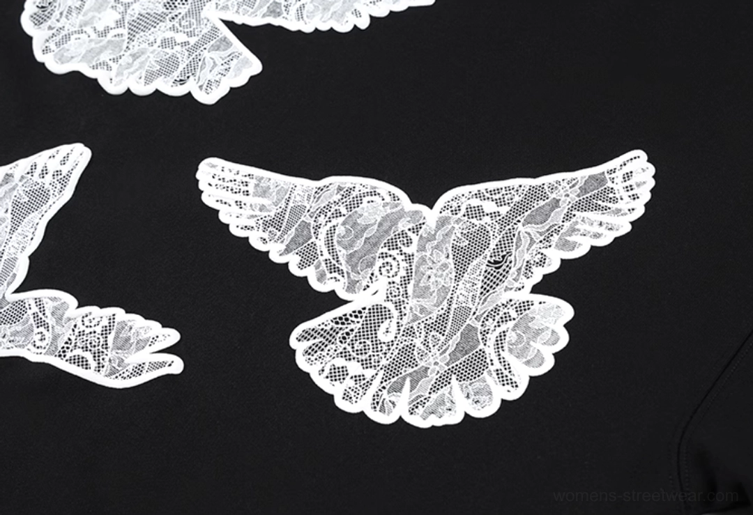 Black lace dove statement hoodie presented in a detailed product and streetwear fashion view