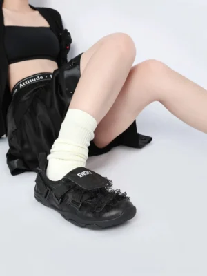 Black lace trim buckle strap ballet sneakers styled with white crew socks and a black leather streetwear skirt