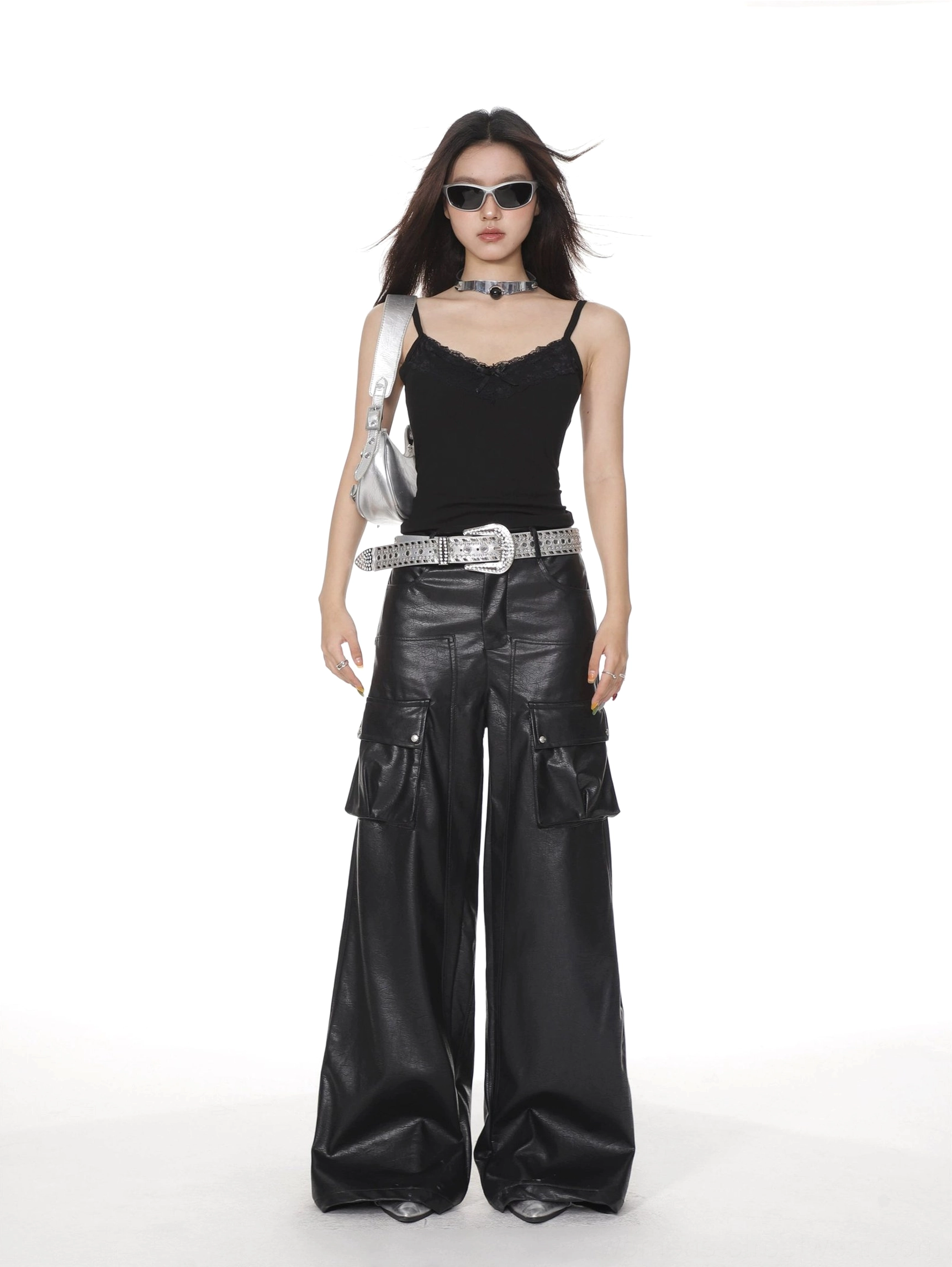 Black lace trim camisole tank top with slim fit V-neck and spaghetti straps styled with black leather cargo pants