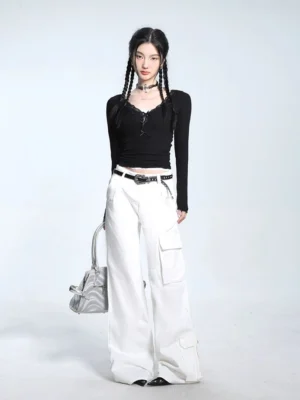 Black slim fit lace trim V-neck long sleeve knit sweater styled with white cargo pants and a leather belt