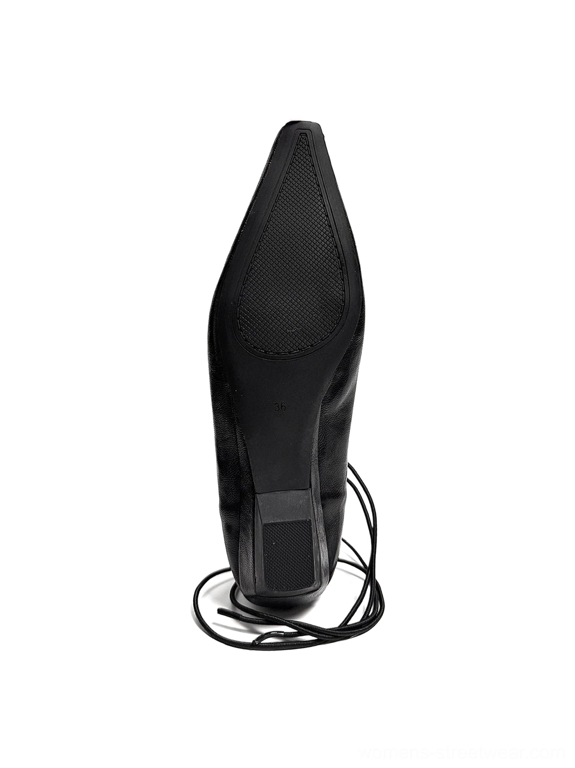Rear bottom profile of a black lace-up ballet flat showing textured non-slip rubber outsole, low heel, and trailing ankle laces