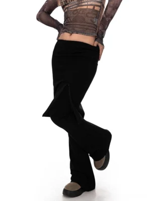 Black layered midi skirt over flared streetwear pants set shown from a back three-quarter view with side split detail