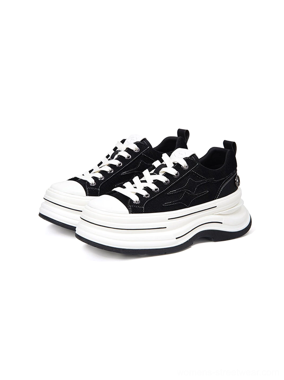 Three-quarter side view of black layered platform canvas sneakers with decorative stitching, white laces, and chunky stacked sole
