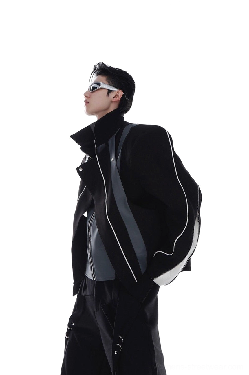 Black layered biker jacket shown from the side with vertical silver zipper stripe details, high stand collar, contrast leather-look torso panels, and oversized fit