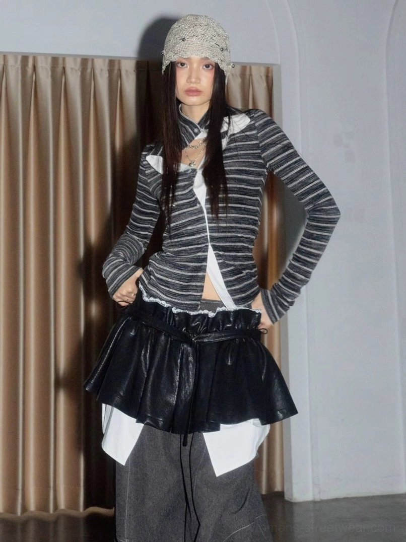 Asian streetwear model wearing a black layered ruffle mini skirt with a striped knit top, wide-leg denim, and crochet bucket hat