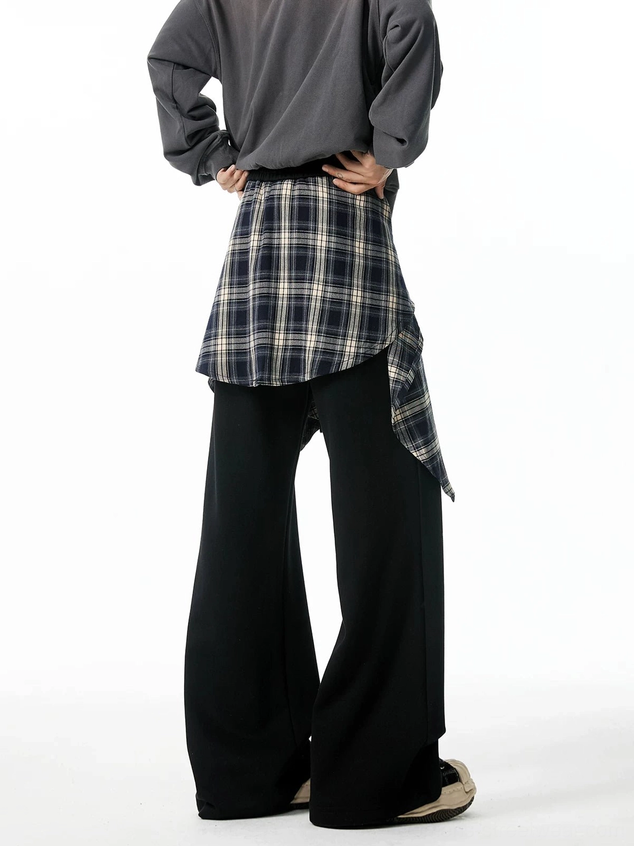 Black layered wide-leg jogger pants with dark plaid flannel waist overlay shown from a right rear three-quarter angle