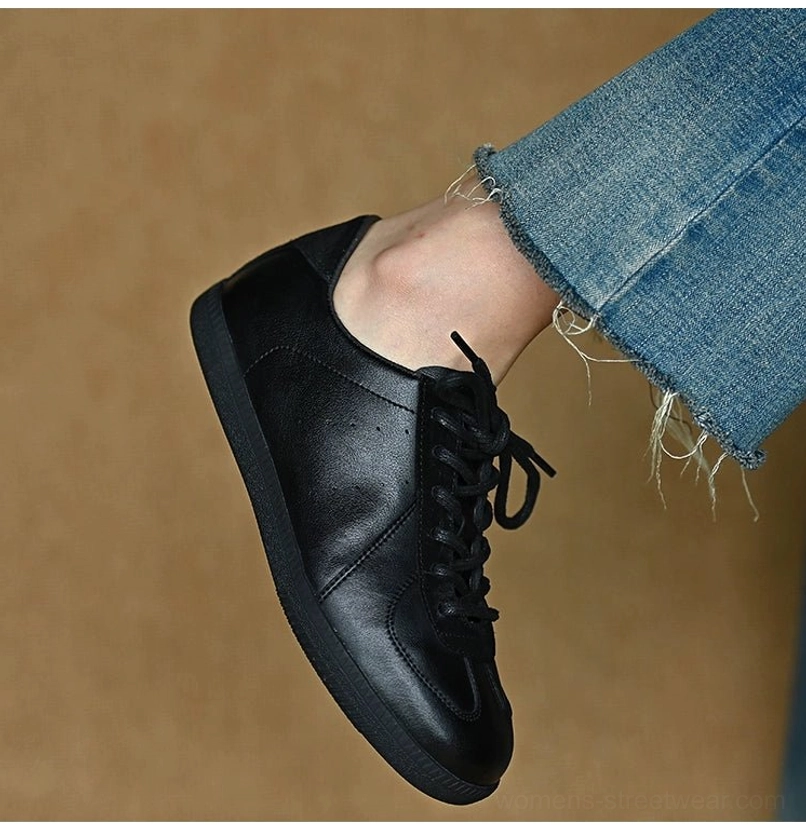 Black leather everyday sneakers worn with frayed cropped jeans for a versatile retro streetwear and casual city outfit