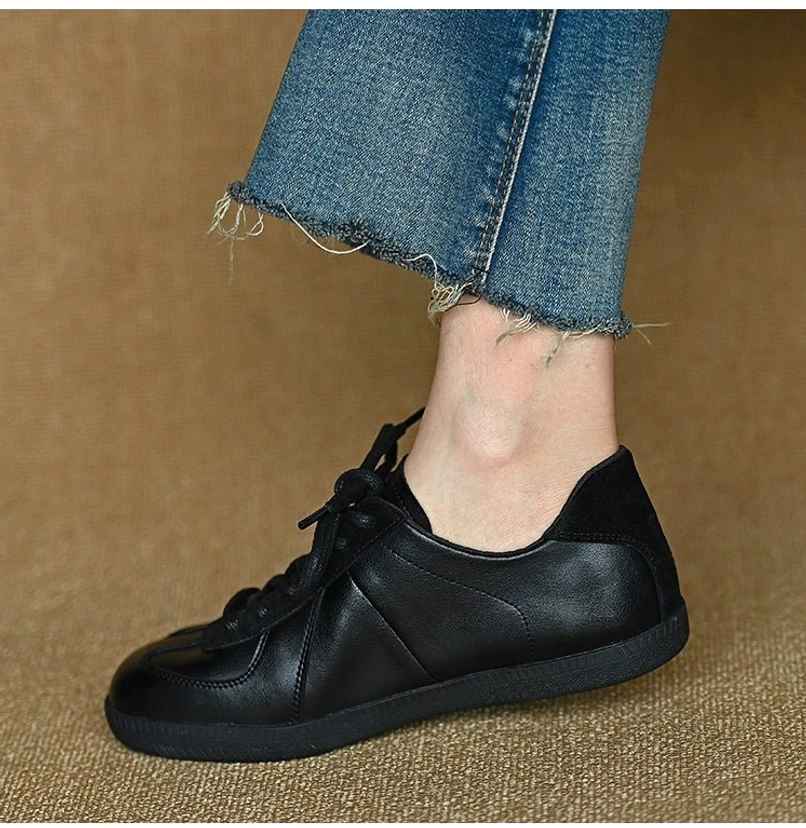 Black leather German trainer-inspired streetwear sneakers with a minimalist low-top silhouette and versatile everyday styling