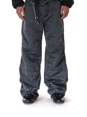 Black leather retro runner sneakers styled with wide-leg cargo pants for a dark monochrome streetwear outfit
