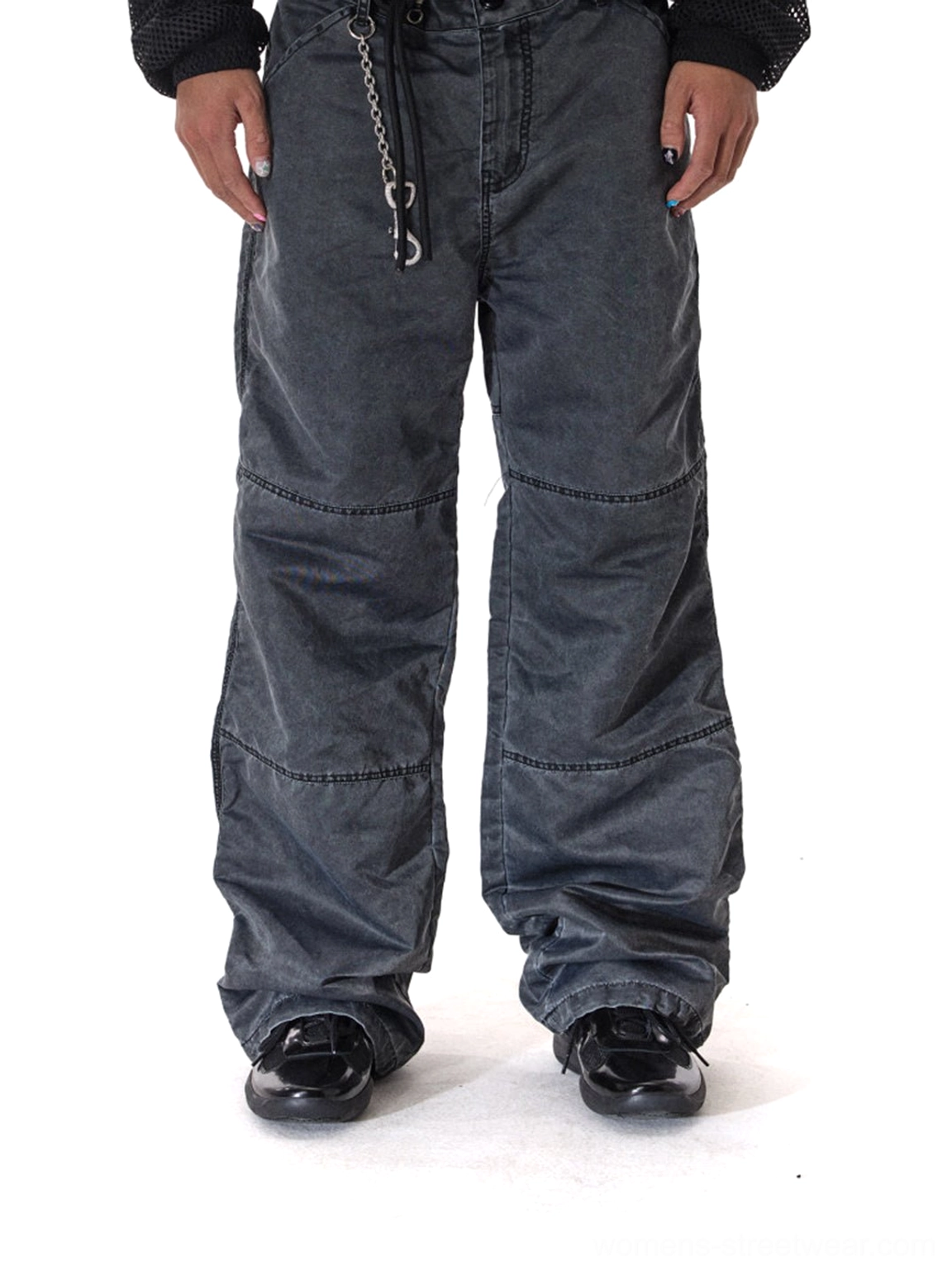 Black leather retro runner sneakers styled with wide-leg cargo pants for a dark monochrome streetwear outfit