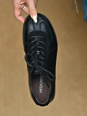 Single black leather retro streetwear sneaker shown from above with visible insole and suede-style toe cap detail