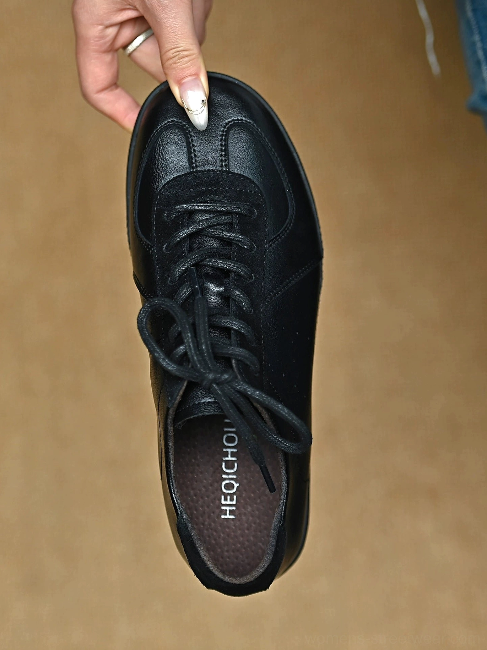 Single black leather retro streetwear sneaker shown from above with visible insole and suede-style toe cap detail