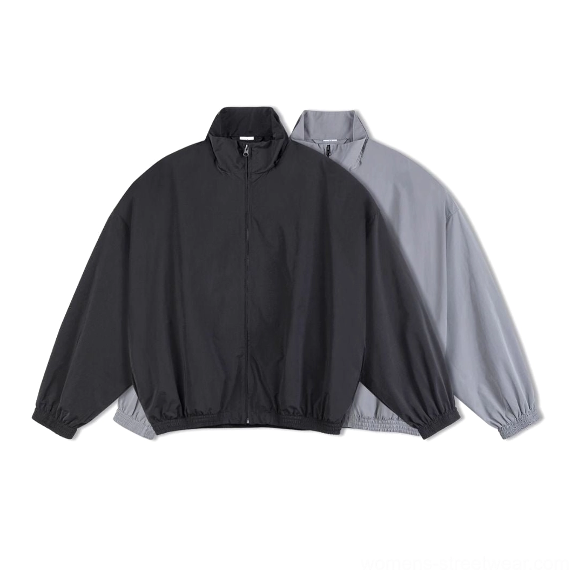 Black and light gray oversized windbreaker jackets displayed together in minimalist streetwear styles