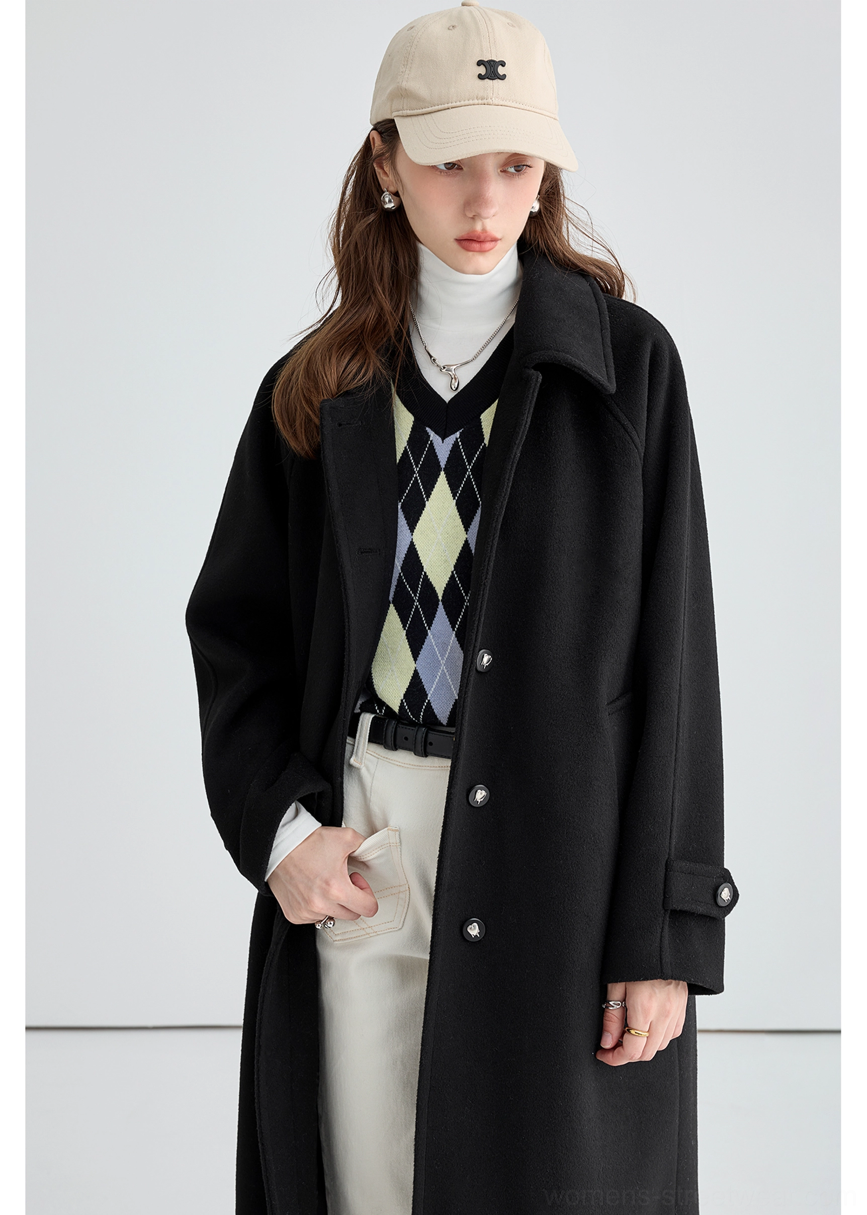 Black long insulated streetwear overcoat detail image highlighting adjustable cuff strap construction