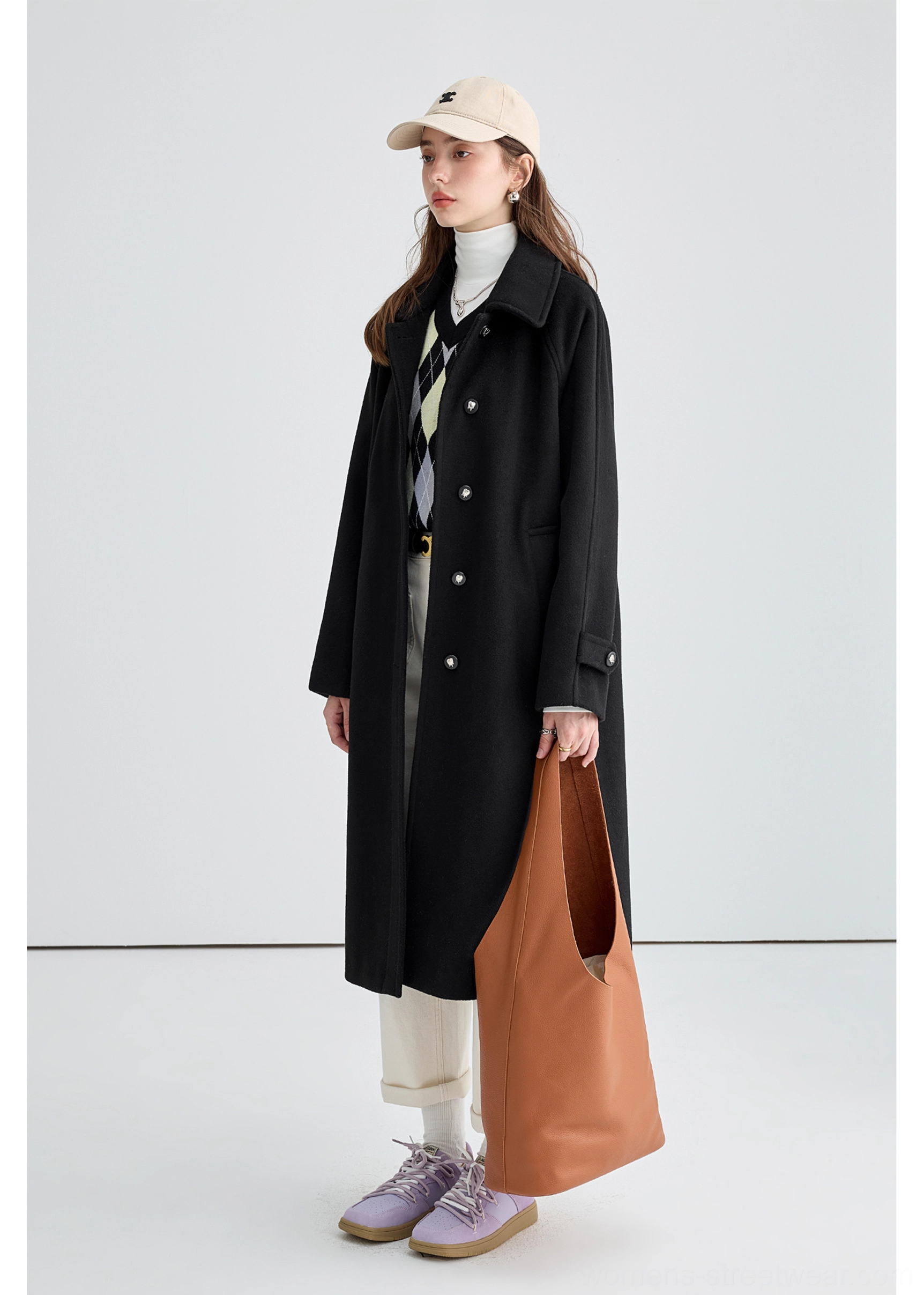 Black long insulated streetwear overcoat product image highlighting long sleeve and cuff adjustment details