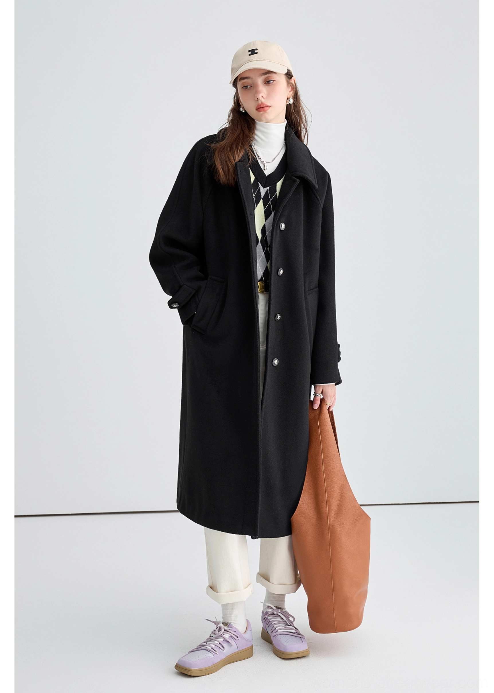 Black long insulated streetwear overcoat product image featuring relaxed longline winter layering