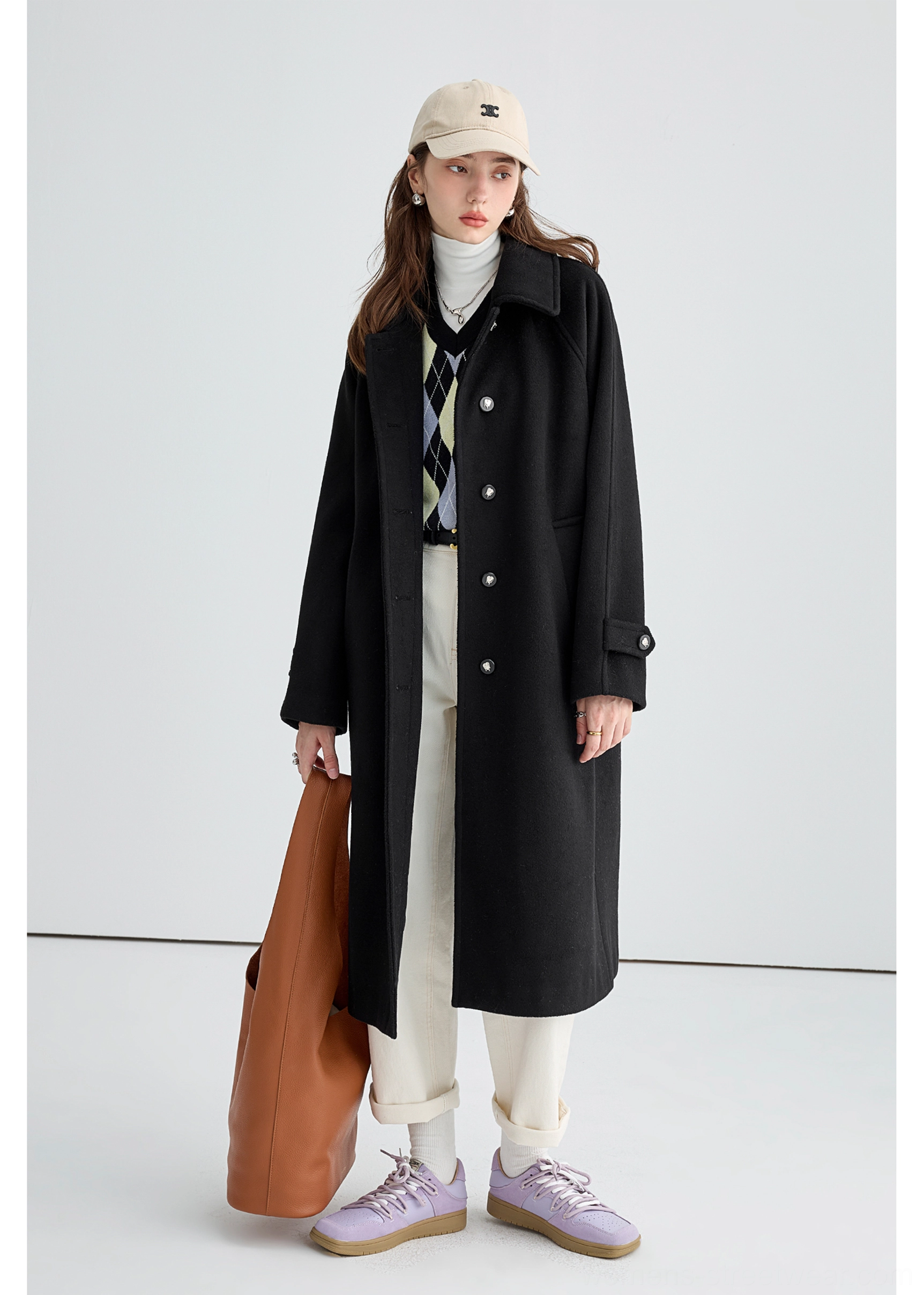 Black long insulated streetwear overcoat product image showing practical side hand pocket detail