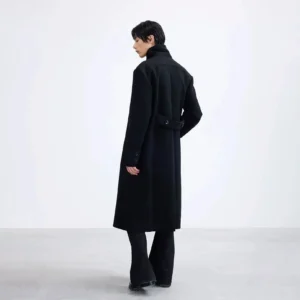 Rear view of a long black polyester overcoat showing the full-length draped silhouette and adjustable back waist detail