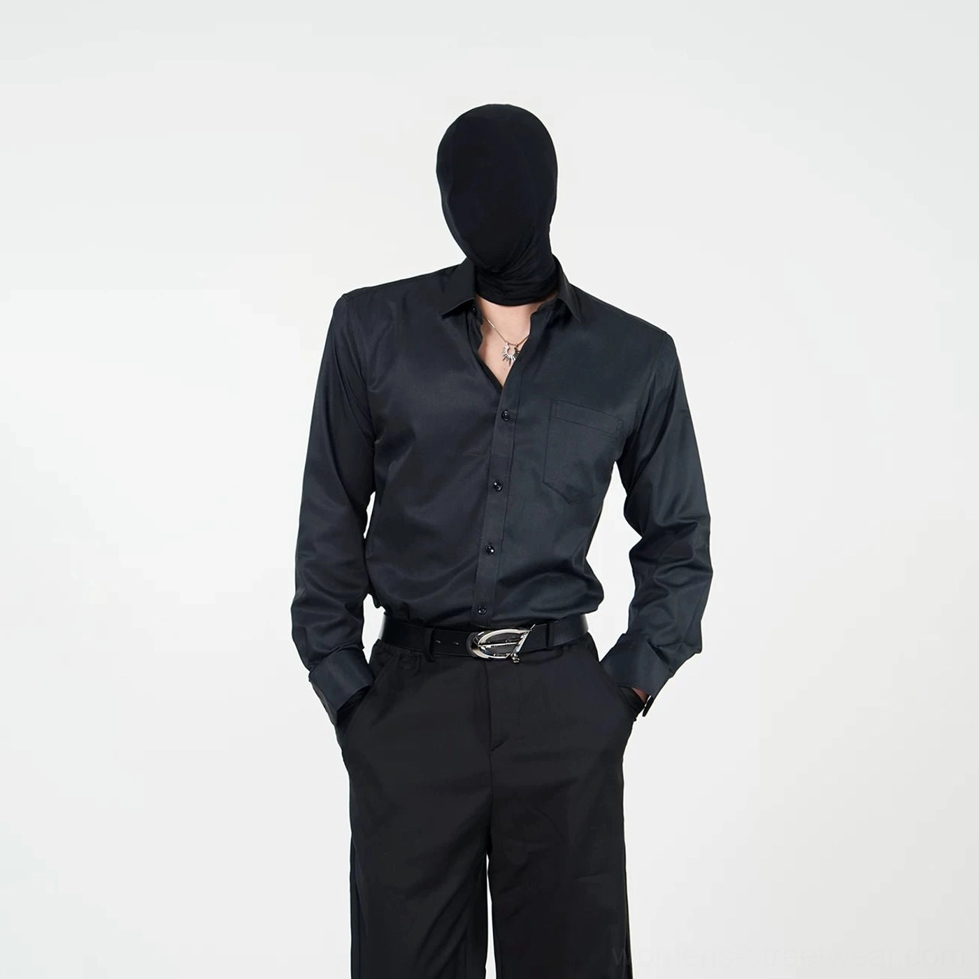 Black long-sleeve point-collar streetwear shirt with open neckline styled with tailored pants and layered neck jewelry