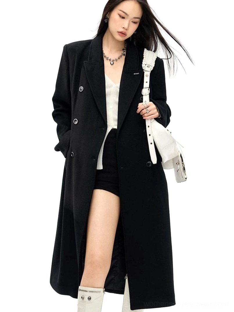 Black long wool coat with double-breasted closure, structured waist and flap pockets styled with shoulder bag