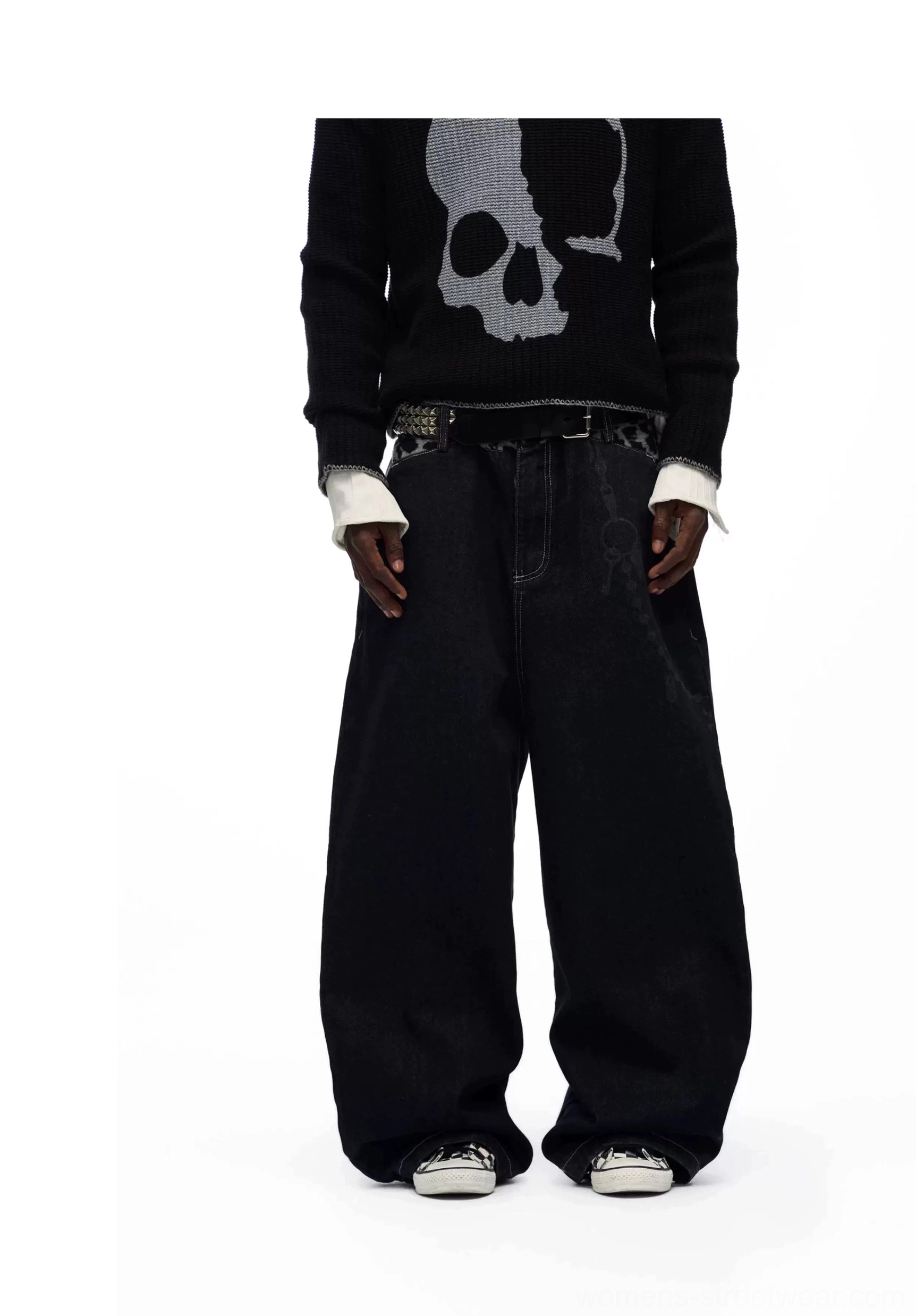 Back studio view of solid black loose wide leg baggy denim jeans styled with a graphic sweater