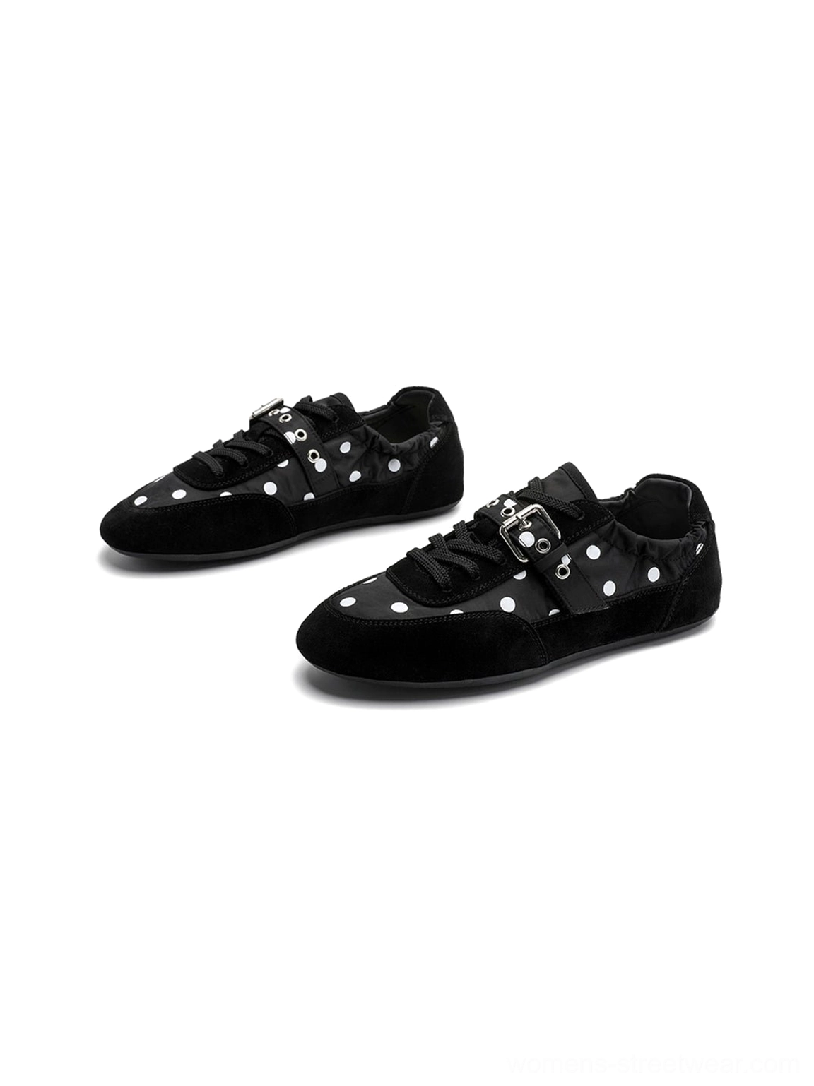 Side view of black low-profile polka dot ballet sneakers highlighting the flat sole and silver instep buckle