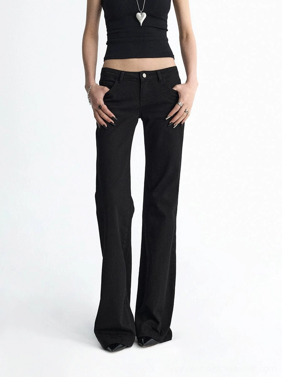 Black low-rise flare jeans with sleek solid denim finish and full-length streetwear trouser silhouette
