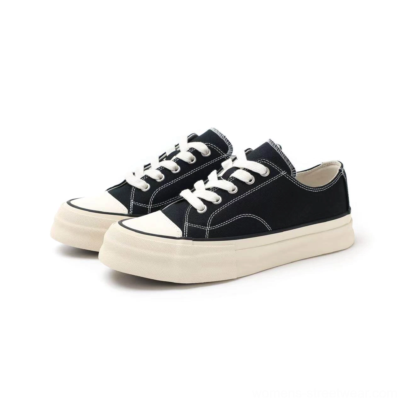 Pair of black low-top canvas platform sneakers with contrast stitching and thick off-white vulcanized rubber soles