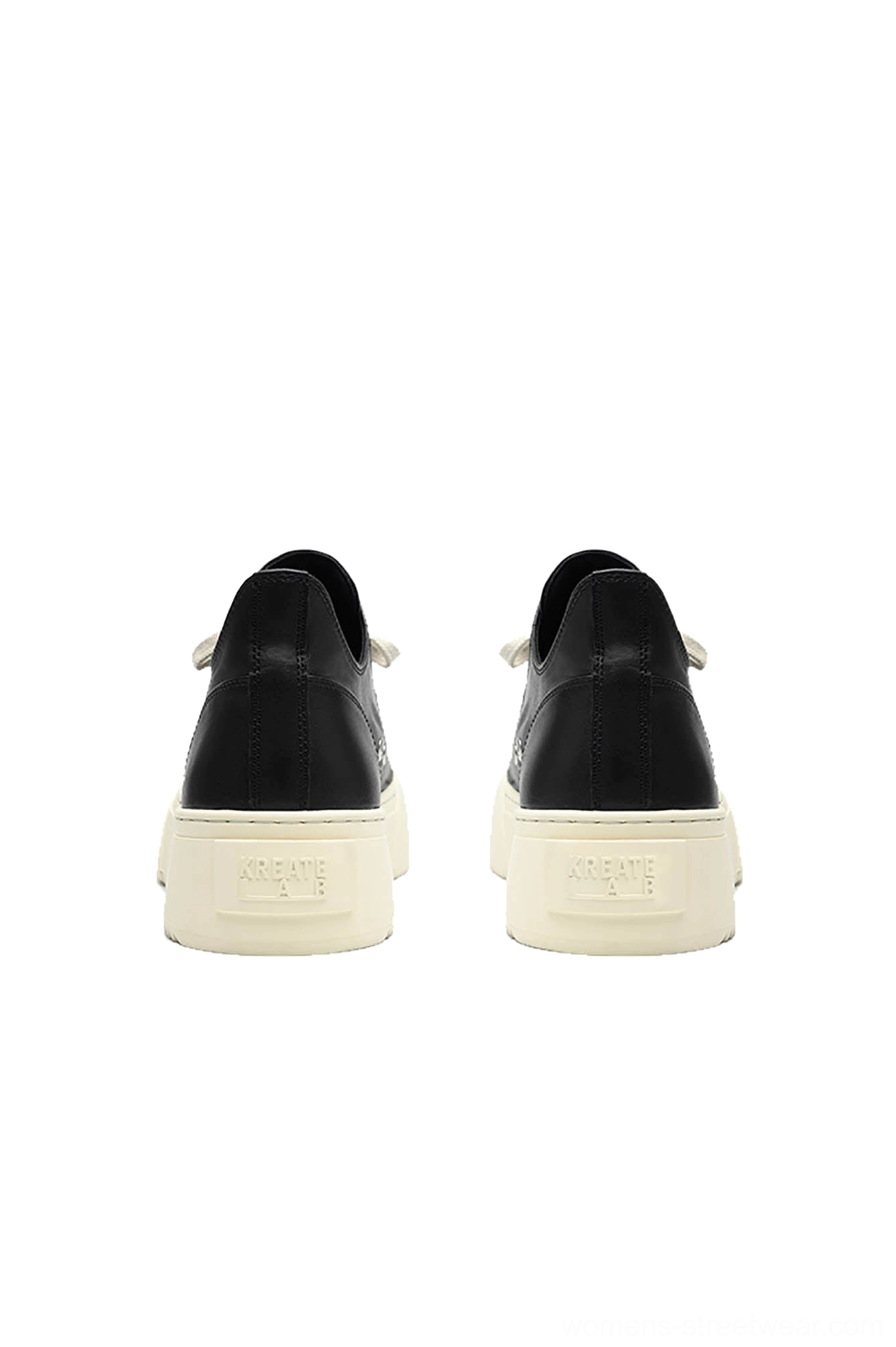 Rear view of black low-top platform sneakers showing solid black heel counters and uniform off-white rubber soles