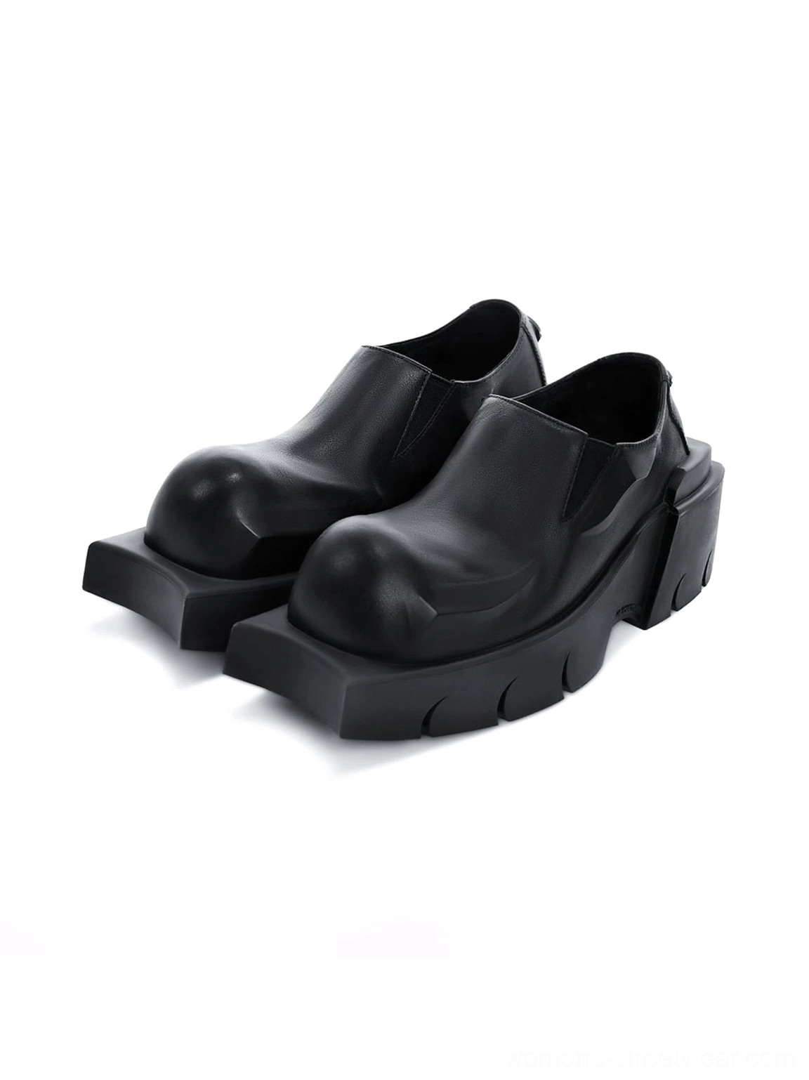 Pair of black matte leather platform derby shoes with rounded square toes and ridged chunky lug soles on a white background