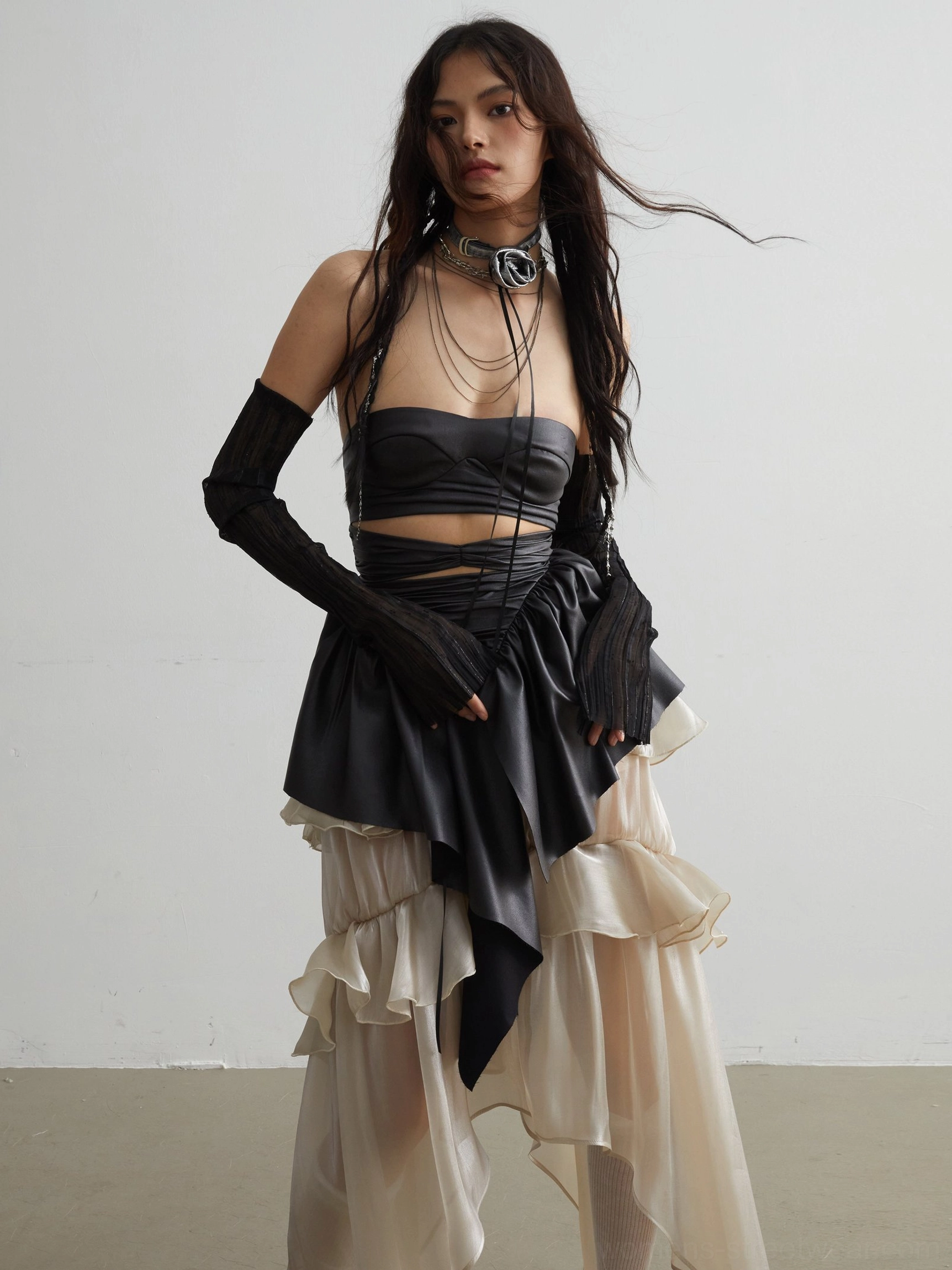 Black matte PU ruffled corset crop top styled with a sheer layered skirt and long black gloves in a dark romantic gothic streetwear outfit