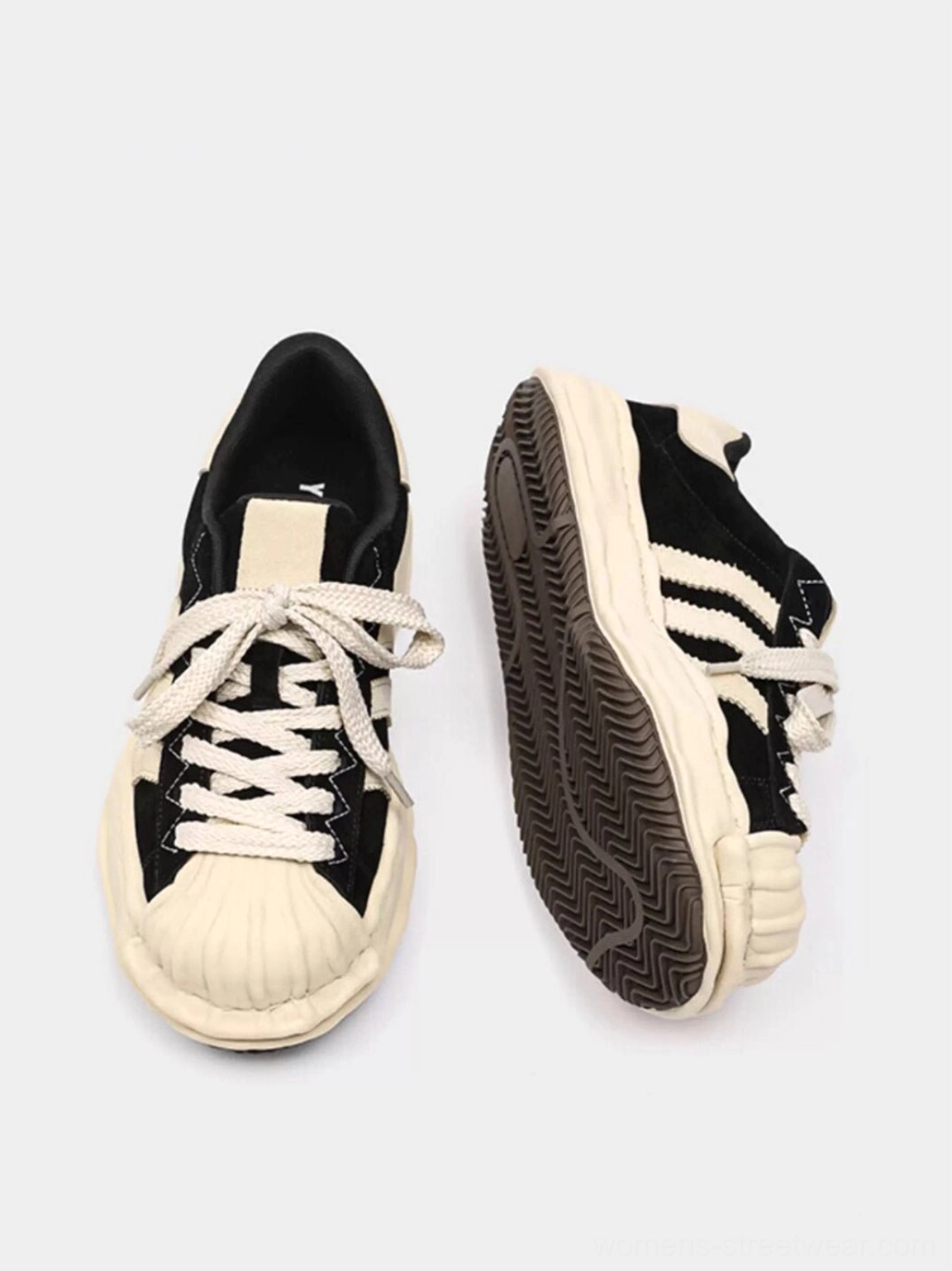 Flat lay front and side view of black melted shell-toe platform sneakers with off-white toe cap, side stripes, laces, and textured outsole
