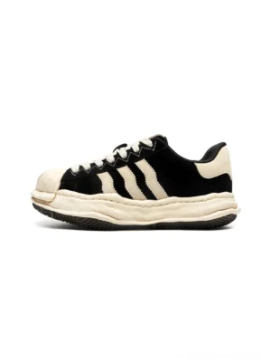 Black melted shell-toe platform sneakers with off-white rubber toe cap, three side stripes, chunky platform sole, and Y2K streetwear design