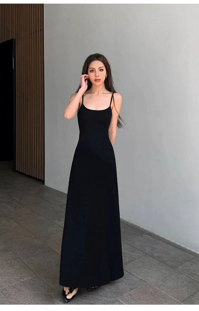 Black minimalist spaghetti strap maxi dress shown in a full front view with black sandals