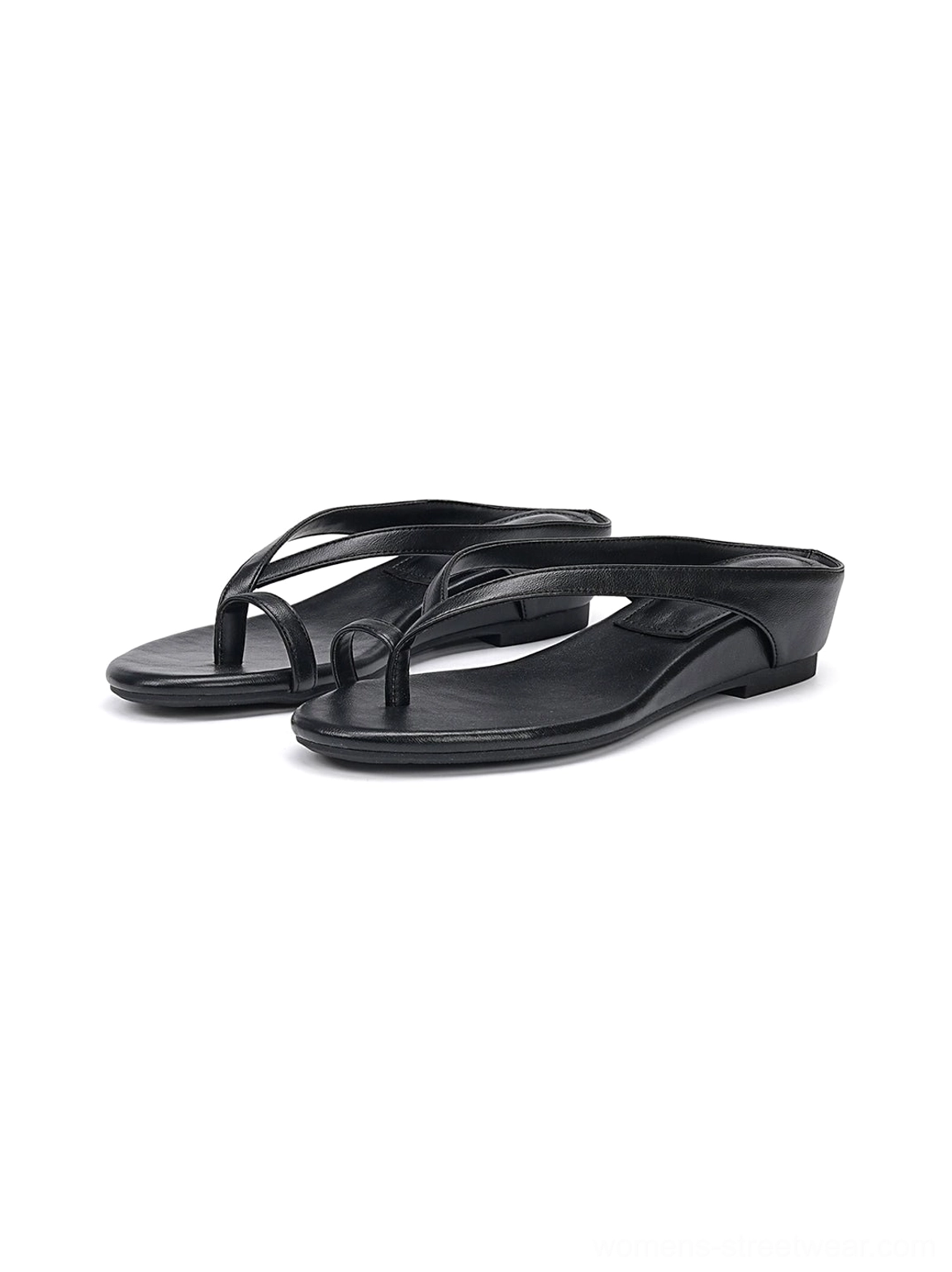 Side flat lay of black minimalist toe ring low wedge flip-flop sandals on a white background