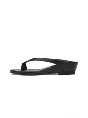 Black minimalist toe ring low wedge flip-flop sandals in side profile on a clean white background