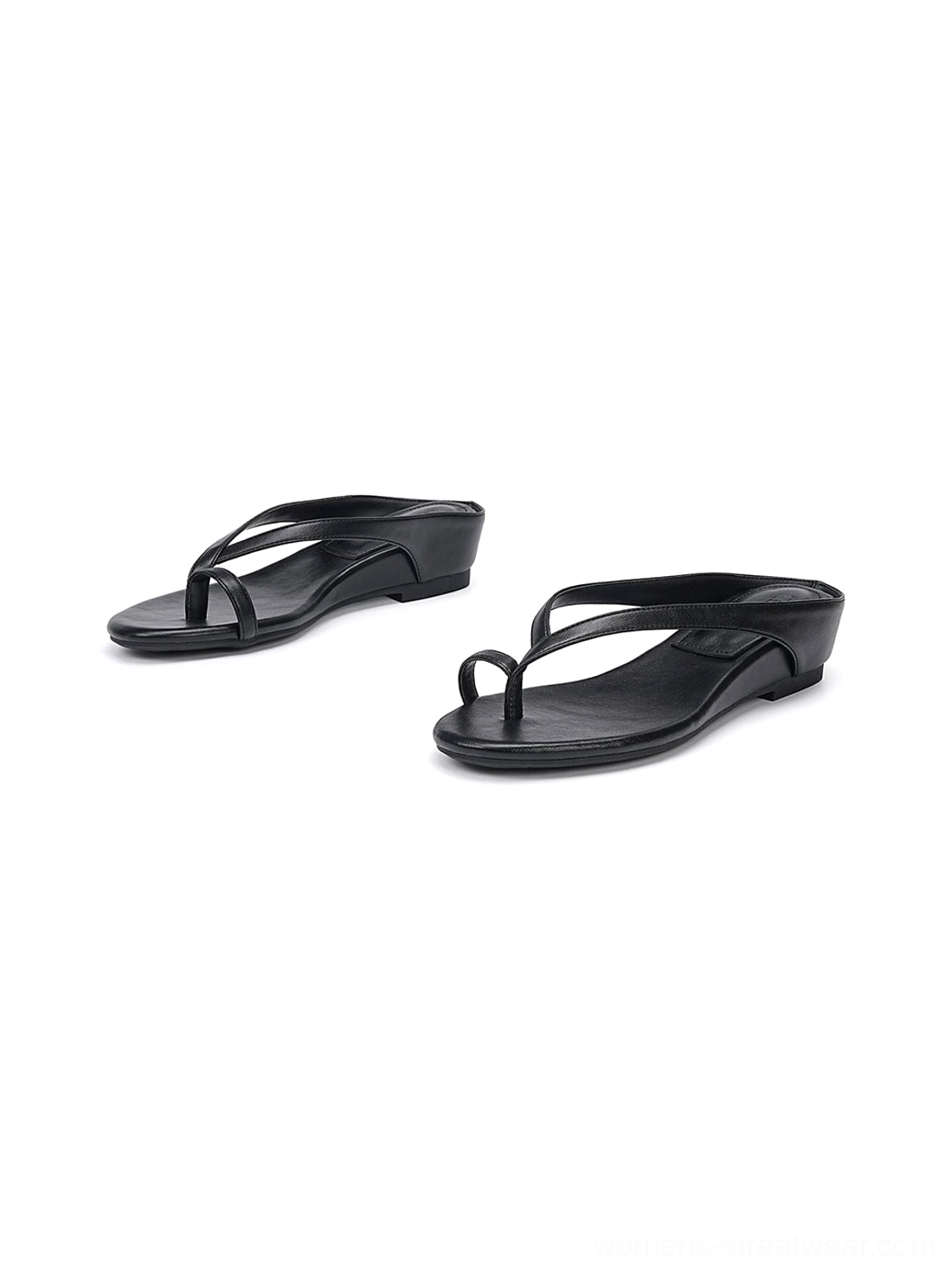 Black minimalist thong sandals with thin toe straps and low wedge soles in paired side view