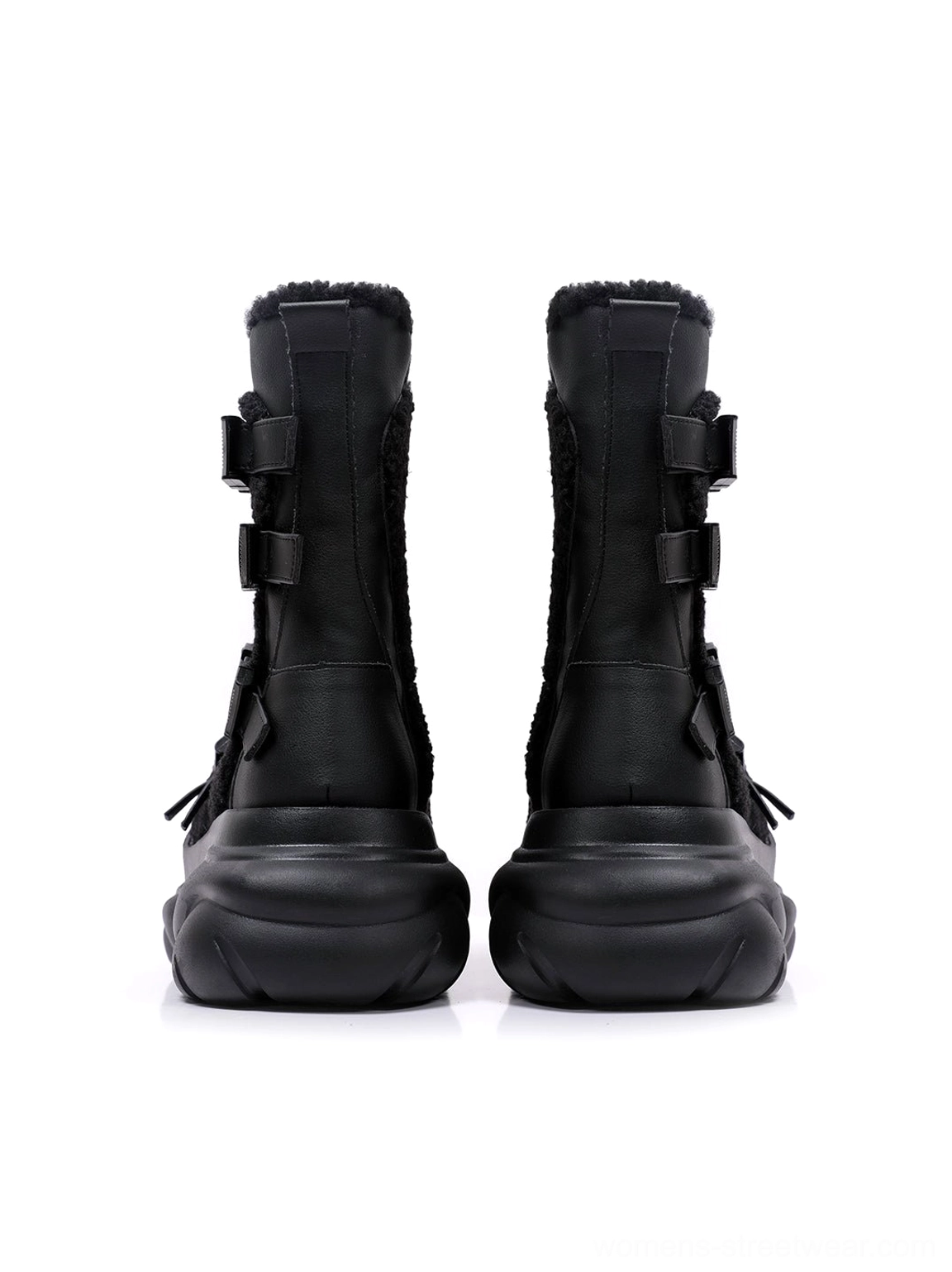 Rear side view of black multi-buckle platform moto boots showing adjustable back straps, tall boot shafts, and soft plush inner lining