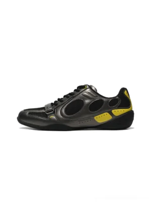 Black and neon yellow retro colorblock low-profile sneakers shown in a left-side product view with gunmetal panels, mesh inserts, lace-up closure, and front strap