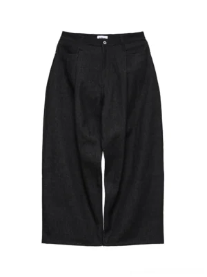 Front flat lay view of black non-fade wide-leg streetwear jeans showing deep black 11.3 oz denim, button fly, front pockets, and relaxed wide-leg cut
